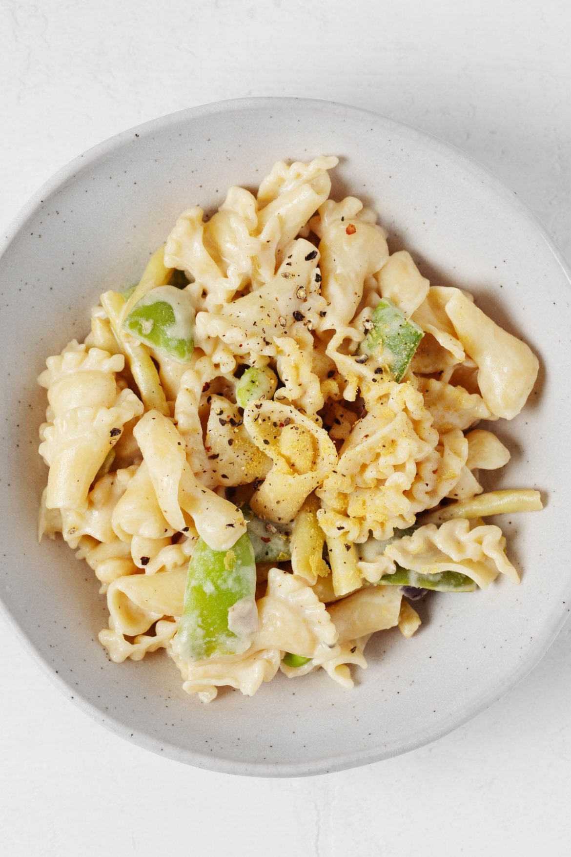 A roasted garlic tahini sauce has been used to make a light, creamy vegan pasta. It